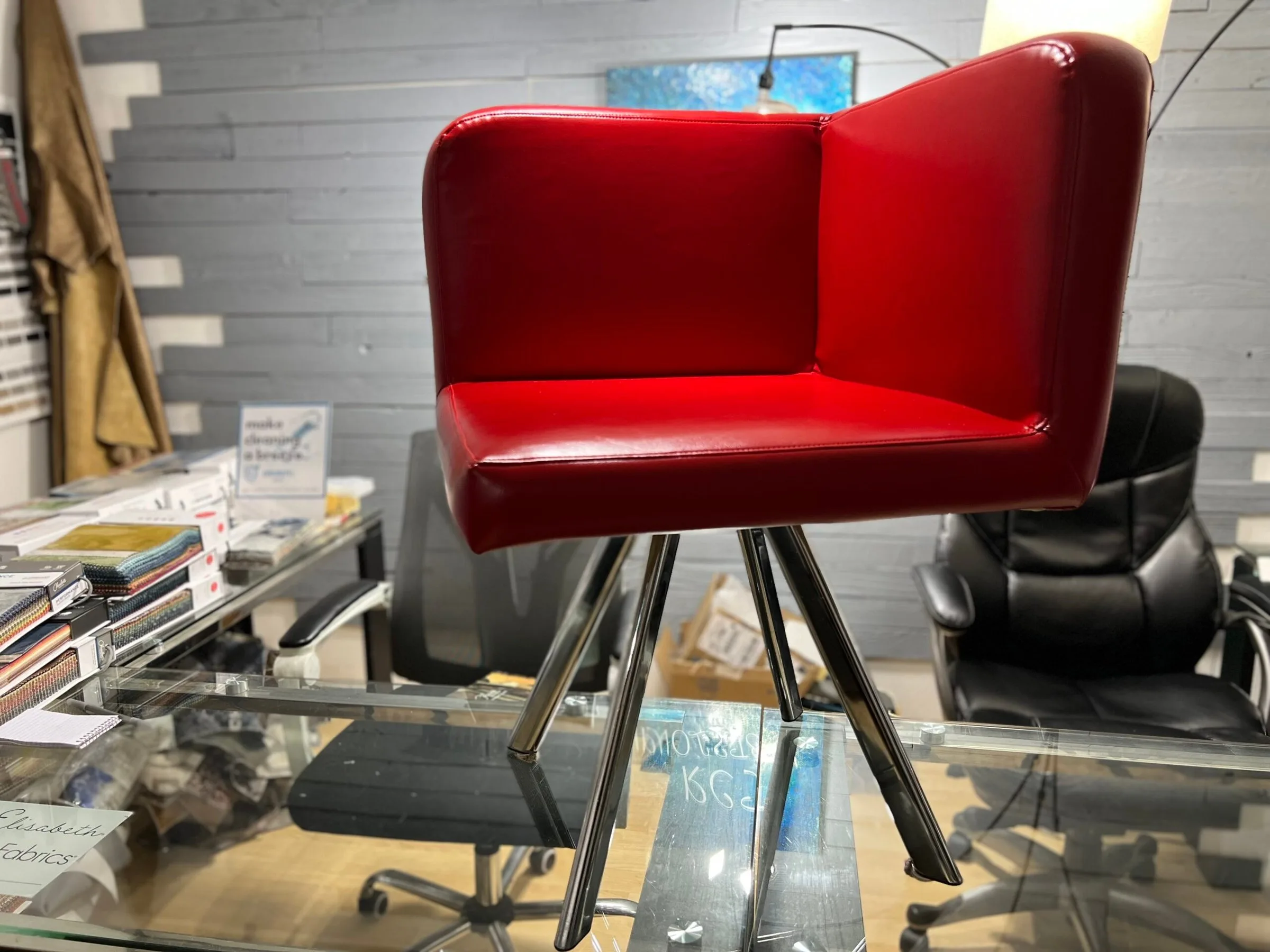 Red vinyl tulip-style accent chair reupholstered by RCT