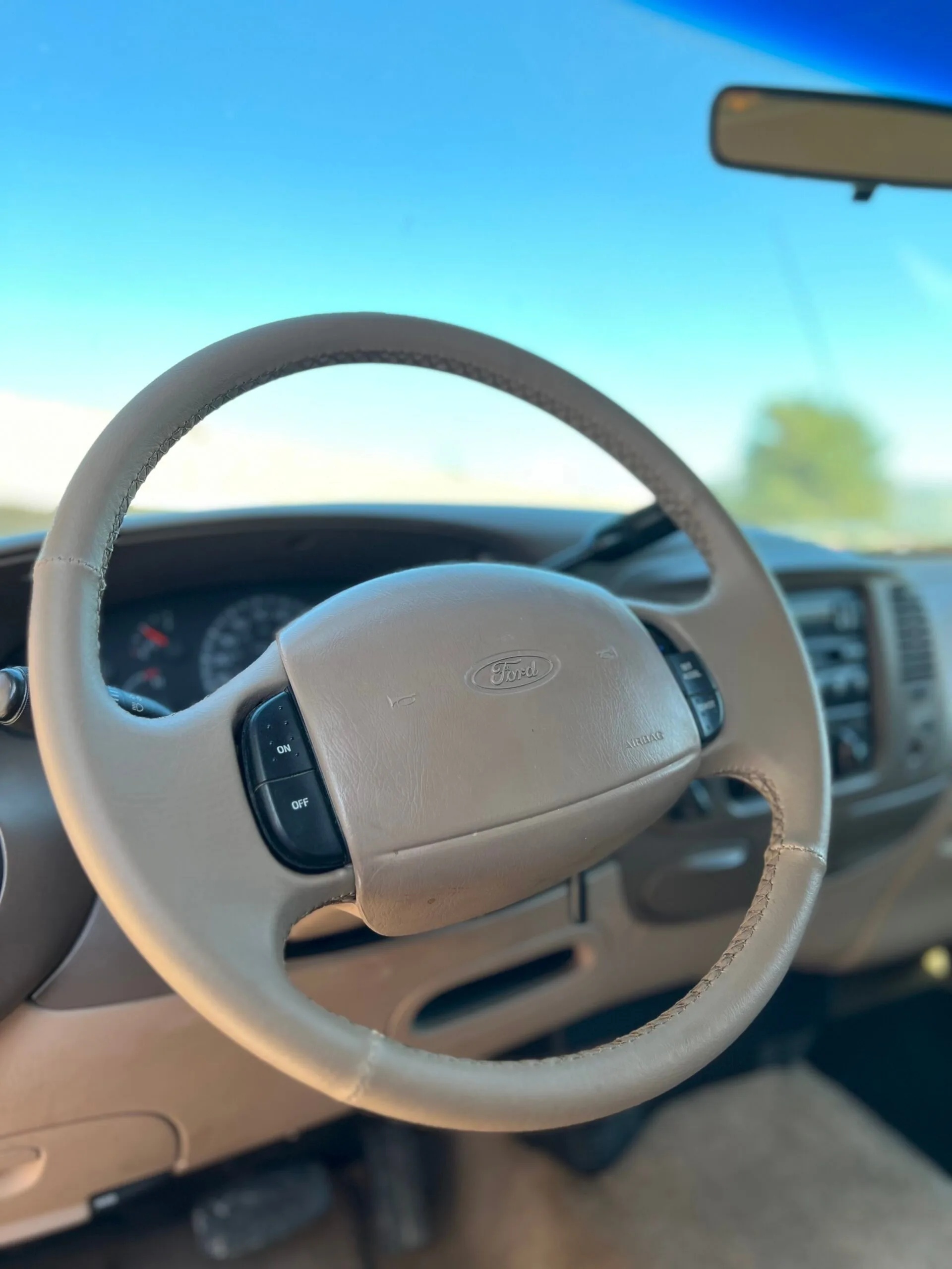 Ford truck steering wheel wrapped in tan leather by RCT automotive